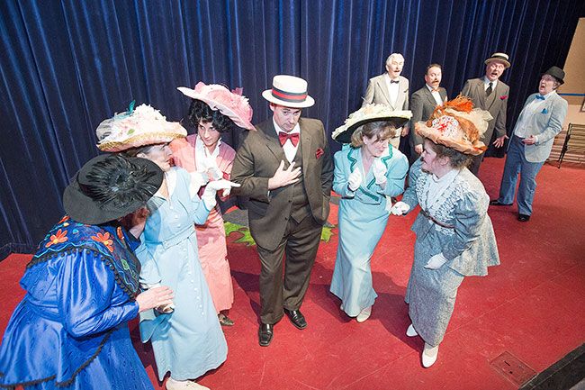 Marcus Larson / News-Register##Harold Hill (Adam Ewing) encourages the River City women to gossip in Gallery Theater s production of  The Music Man. 