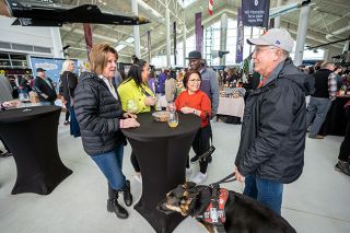 Rachel Thompson/News-Register file photo##Salem visitors enjoy last year’s Wine & Food Classic. From left are Donna Kahnamooian, Andrea Wandera, Daniel Wandera, Margaritha Stewart, Ron Stewart and service dog, Zoey. Advance tickets sales for this year’s event were up by half, organizers say.