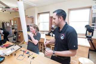 Marcus Larson/News-Register##Delphian teacher Diego Martinez supervises student Quinn Bennett as she adds drone motors to her vertical landing rocket. The project is for the national science fair. Marcus Larson/News-Register##Delphian teacher Diego Martinez supervises student Quinn Bennett as she adds drone motors to her vertical landing rocket. The project is for the national science fair.
