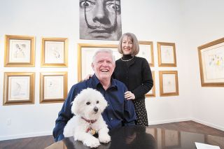 Marcus Larson/News-Register file photo##Gary and Signe Lawrence pose with Juliette, their Bichon Frise, in the museum room they created for the Salvador Dali show. Photo taken in 2013 just before the show opened. Marcus Larson/News-Register file photo##Gary and Signe Lawrence pose with Juliette, their Bichon Frise, in the museum room they created for the Salvador Dali show. Photo taken in 2013 just before the show opened.