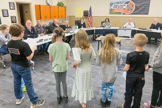 Starla Pointer/News-Register##Third-graders tell the Yamhill Carlton School board and administrators about their “Fish to Fry” projects. They watched trout eggs hatched and monitored the babies, called “fry,” until they were old enough to swim in a river. They also made papier mache models of each stage, from egg to fry.