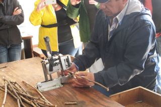 Karl Klooster/News-RegisterDuck Pond Vineyard Foreman Manuel Hernandez demonstrates grafting of a scion to a disease-resistant root stock.