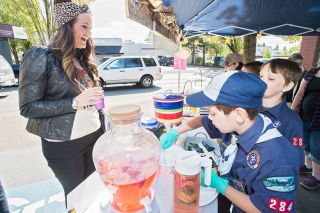 Marcus Larson/News-Register##Cub Scout Pack 7284 member Jordan Phillips fills
an order for Analiese Jones during Lemonade Day
on Saturday. The Scouts set up shop in the First Federal parking lot, where they peddled fizzy Pop Rocks-spiked lemonade.