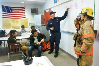Starla Pointer / News-Register##
As eighth-grader Colin Urquhart models firemen s turnouts, Justin Amentrout tells his Duniway classmates about working as a firefighter and EMT in Portland. Every day is different, he said, but whatever he does on the job, he knows he s helping people. Starla Pointer / News-Register##
As eighth-grader Colin Urquhart models firemen s turnouts, Justin Amentrout tells his Duniway classmates about working as a firefighter and EMT in Portland. Every day is different, he said, but whatever he does on the job, he knows he s helping people.