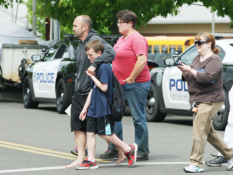 Rockne Roll/News-Register##A family departs Grandhaven Elementary School in McMinnville following a
lockdown after a threat was made against the students Wednesday, May 13.
Police arrived to secure the school soon after the threat was made.