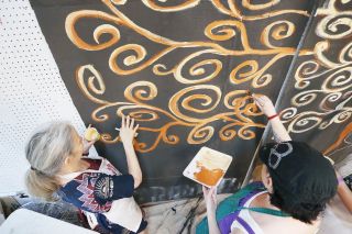 Rockne Roll/News-Register##Nadya King, left, and Terra Stein paint in a section of Sepha Nisbet s Witness Tree in the Currents Back Door Studio in McMinnville. Rockne Roll/News-Register##Nadya King, left, and Terra Stein paint in a section of Sepha Nisbet s Witness Tree in the Currents Back Door Studio in McMinnville.