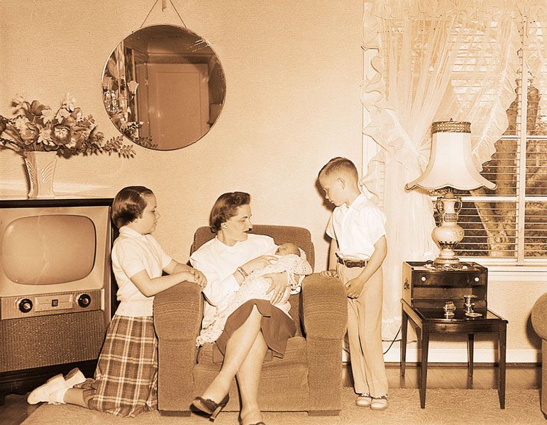News-Register file photo##May 7, 1955. But mom, She’s so little — Just nine days old on Mother’s Day will be Marsha Jean Colvin, daughter of Mr. and Mrs. C.E. Colvin. Older daughter, Carolyn, 10, and son, Mike, 6, look with wonder at their tiny baby sister held by Mrs. Colvin. Mother’s Day will have special importance this year in the Colvin family.