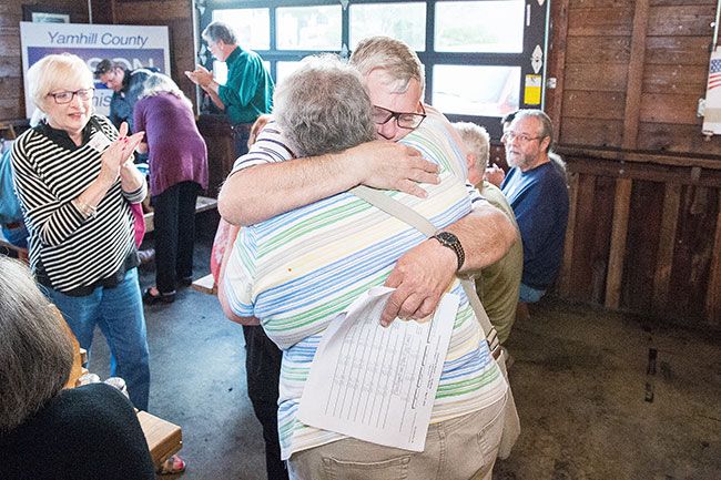 Marcus Larson/News-Register##After arrive back at the Grain Station party, Mayor Rick Olson hugs his wife, Candy, celebrating his early lead in the Yamhill County Commissioners race.