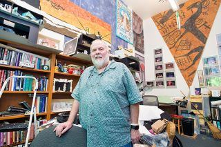 Marcus Larson/News-Register##Ty Marshall in his Linfield College office, which is filled with set designs and memorabilia from his 31 years as a set designer and theater professor at the school. Marshall is retiring, but will continue working on the dory project he started with students and Brenda Devore Marshall, his wife and Linfield colleague. Marcus Larson/News-Register##Ty Marshall in his Linfield College office, which is filled with set designs and memorabilia from his 31 years as a set designer and theater professor at the school. Marshall is retiring, but will continue working on the dory project he started with students and Brenda Devore Marshall, his wife and Linfield colleague.