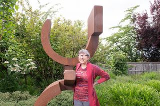 Rusty Rae/News-Register##Woman of the Year Ronni Lacroute loves and values the arts, including sculptures such as this one in her yard. The arts bring us together and make us better people, she said.