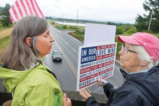 Submitted photo##Suey Linzmeier of Sheridan and Beth Dell of McMinnville protest federal immigration policies Sunday at the South Bridge Street overpass over Highway 18 near the federal prison in Sheridan. Submitted photo##Suey Linzmeier of Sheridan and Beth Dell of McMinnville protest federal immigration policies Sunday at the South Bridge Street overpass over Highway 18 near the federal prison in Sheridan.