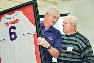 Tim Marsh for the News-Register##
Scott Carnahan with the framed retired jersey and Ad Rutschman share a few words after Rutschman announced the school had retired his jersey. Tim Marsh for the News-Register##
Scott Carnahan with the framed retired jersey and Ad Rutschman share a few words after Rutschman announced the school had retired his jersey.