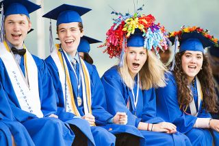 Marcus Larson/News-Register##Amity High graduates from left, Dylan Stearns, Daniel Mather, Macey Walker and Bailie Jacobo-Safranski react to comical refrences to their classmates made by the commencement speaker. Marcus Larson/News-Register##Amity High graduates from left, Dylan Stearns, Daniel Mather, Macey Walker and Bailie Jacobo-Safranski react to comical refrences to their classmates made by the commencement speaker.