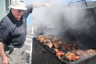 Submitted photo##Ted Mayfield shows off some barbecued chicken during a previous Sheridan Days festival.