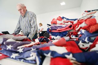 Rockne Roll / News-Register##American Legion member Marv Worden sorts through flags submitted for retirement. Rockne Roll / News-Register##American Legion member Marv Worden sorts through flags submitted for retirement.