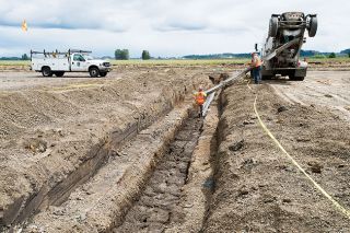 Marcus Larson/News-Register##
Workers cover a large drainage pipe with cement at part of the McMinnville Airport s runway reconstruction project, due to be completed this fall. Planes are using the second runway this summer. Marcus Larson/News-Register##
Workers cover a large drainage pipe with cement at part of the McMinnville Airport s runway reconstruction project, due to be completed this fall. Planes are using the second runway this summer.