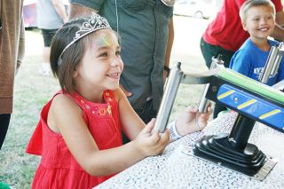 News-Register file photo##Four-year-old Norah Guardiola of Willamina awaits her prize after winning a carnival game during last year’s Sheridan Days celebration.