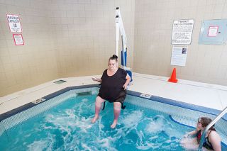 Marcus Larson / News-Register##
Peg Wilson operates the new lift that lowers her slowly into the hot tub at the McMinnville Aquatic Center. She said she s been looking forward to using the lift. Marcus Larson / News-Register##
Peg Wilson operates the new lift that lowers her slowly into the hot tub at the McMinnville Aquatic Center. She said she s been looking forward to using the lift.