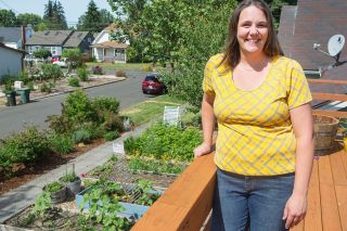 Rockne Roll/News-Register##Hannah DeMaster grows flowers and vegetables in raised beds in her front yard. Her three children “enjoy watching things grow,” she said. Rockne Roll/News-Register##Hannah DeMaster grows flowers and vegetables in raised beds in her front yard. Her three children “enjoy watching things grow,” she said.
