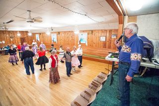 Marcus Larson/News-Register##Square dance caller Leonard Snodgrass calls out each move during the Braids & Braves dance. Snodgrass said he has to plan the calls so couples end up together. Marcus Larson/News-Register##Square dance caller Leonard Snodgrass calls out each move during the Braids & Braves dance. Snodgrass said he has to plan the calls so couples end up together.