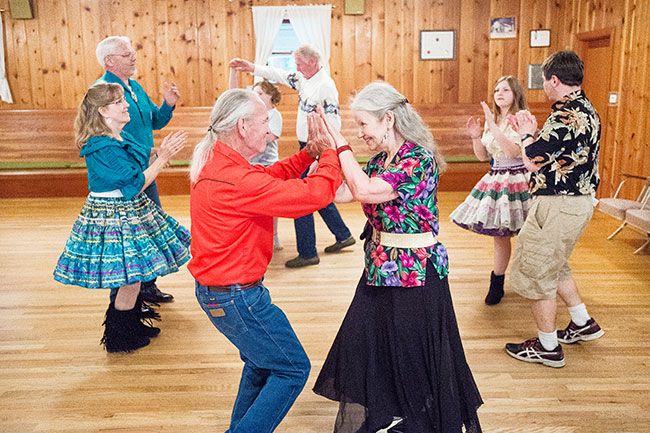 Marcus Larson/News-Register##Square dancers Mike Yoder and Nadya King meet while performing a dance move at the Braids & Braves final get-together in the McMinnville Grange. The club will move to Dayton in September.