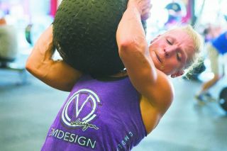 Rockne Roll/News-Register##
Dani Miles wrestles with a medicine ball during one segment of her workout. Rockne Roll/News-Register##
Dani Miles wrestles with a medicine ball during one segment of her workout.