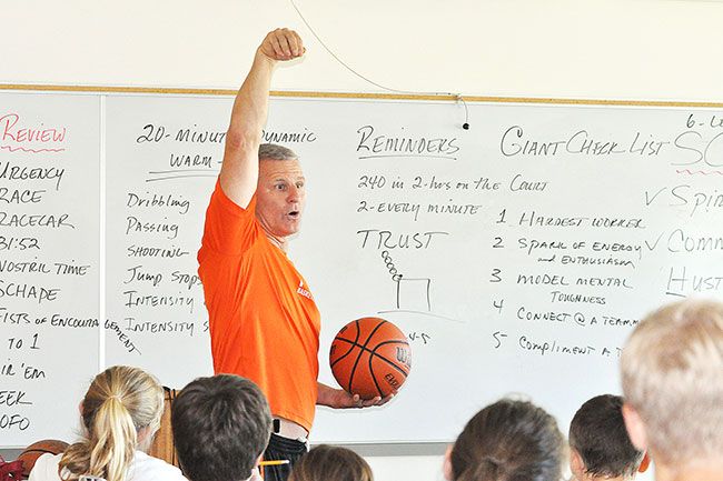 Robert Husseman/News-RegisterLarry Doty instructs campers on proper jumpshot follow-through during a classroom session.