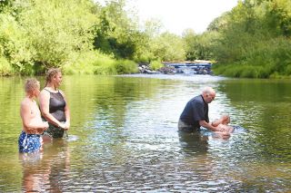 Rockne Roll / News-Register##Pastor Kevin Cope baptises Quintin McAvoy, 10, in the North Yamhill River Sunday. It was Carlton First Baptist Church s first river baptism in decades. Rockne Roll / News-Register##Pastor Kevin Cope baptises Quintin McAvoy, 10, in the North Yamhill River Sunday. It was Carlton First Baptist Church s first river baptism in decades.