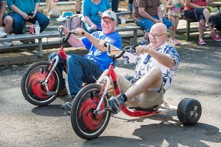 Marcus Larson/News-Register##
Yamhill Derby Days emcee Bob Landauer races against Brian King in the grandpa class of the trike races. Marcus Larson/News-Register##
Yamhill Derby Days emcee Bob Landauer races against Brian King in the grandpa class of the trike races.