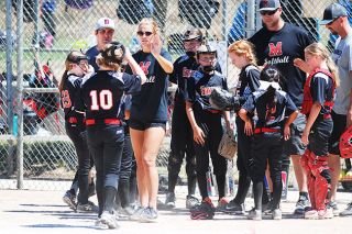 Logan Brandon/News-Register##
Michaela Shouldis trades high fives with members of the McMinnville 10U team during a game earlier this summer. Logan Brandon/News-Register##
Michaela Shouldis trades high fives with members of the McMinnville 10U team during a game earlier this summer.