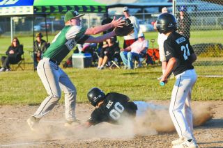Rusty Rae/News-Register##
Nate Arce slides home, beating the throw from the catcher on a passed ball as Dylan Webster looks on. Rusty Rae/News-Register##
Nate Arce slides home, beating the throw from the catcher on a passed ball as Dylan Webster looks on.