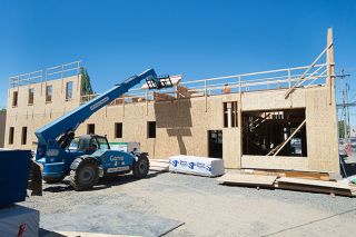 Marcus Larson/News-Register##Construction crews last week began framing the second of four floors of the Atticus Hotel at the corner of Fourth and Ford streets in downtown McMinnville. Marcus Larson/News-Register##Construction crews last week began framing the second of four floors of the Atticus Hotel at the corner of Fourth and Ford streets in downtown McMinnville.