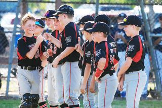Logan Brandon/News-Register##
Caleb Primbs (16) receives fist bumps from his teammates during introductions to the state tournament held at Bob Smith Memorial Park in Lebanon. Logan Brandon/News-Register##
Caleb Primbs (16) receives fist bumps from his teammates during introductions to the state tournament held at Bob Smith Memorial Park in Lebanon.