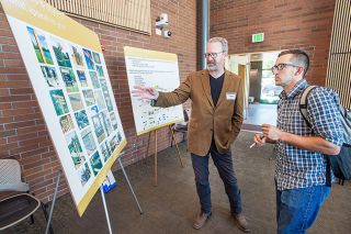 Marcus Larson/News-Register##Jack Chapman, right, chats with Peter Reedijk, design director for Sheridan company Sea Reach, about what designs best represent McMinnville if used for signage. Marcus Larson/News-Register##Jack Chapman, right, chats with Peter Reedijk, design director for Sheridan company Sea Reach, about what designs best represent McMinnville if used for signage.