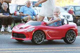 Rockne Roll/News-Register##A young parade participant pilots her Dodge Viper-styled riding toy on Third Street in Dayton during last year’s Dayton Old Timers Weekend parade.