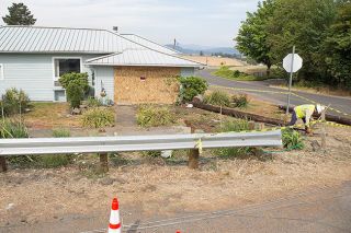 Rockne Roll/News-Register##A Range Rover SUV crashed into this house at the corner of Pike Road and Highway 47 in Yamhill, pictured Sunday, Aug. 6, taking out a utility pole along the way. Portland General Electric crews worked throughout Sunday to repair downed lines, seen here in the foreground. Rockne Roll/News-Register##A Range Rover SUV crashed into this house at the corner of Pike Road and Highway 47 in Yamhill, pictured Sunday, Aug. 6, taking out a utility pole along the way. Portland General Electric crews worked throughout Sunday to repair downed lines, seen here in the foreground.