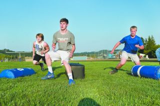 Marcus Larson/News-Register##
Amity football players (l-r) West Streeter, Brian Hatch and Tyler Parr fly through an agility drill during Tuesday’s training camp. All three players are crucial to the flow of the Warrior offense. Marcus Larson/News-Register##
Amity football players (l-r) West Streeter, Brian Hatch and Tyler Parr fly through an agility drill during Tuesday’s training camp. All three players are crucial to the flow of the Warrior offense.