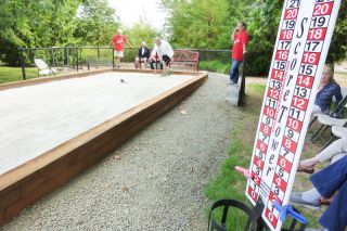 Starla Pointer / News-Register##As Hillside residents play, bocce points add up on a scoreboard at one side of the new court. Residents enjoy the fun of bocce, as well as the challenge of knocking their neighbors’ balls away from the target. Starla Pointer / News-Register##As Hillside residents play, bocce points add up on a scoreboard at one side of the new court. Residents enjoy the fun of bocce, as well as the challenge of knocking their neighbors’ balls away from the target.