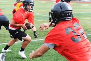 Rusty Rae/News-Register##
Junior QB Sam DuPuis turns to handoff to running back Anthony Myers during practice Monday morning at Wortman Stadium. Rusty Rae/News-Register##
Junior QB Sam DuPuis turns to handoff to running back Anthony Myers during practice Monday morning at Wortman Stadium.