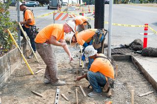 Marcus Larson/News-Register##
Chris Szedlak with Concrete Solutions directs workers while measuring the angle of the new sidewalk installation near Yamhill-Carlton Intermediate School. Marcus Larson/News-Register##
Chris Szedlak with Concrete Solutions directs workers while measuring the angle of the new sidewalk installation near Yamhill-Carlton Intermediate School.