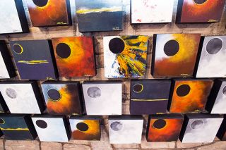 Marcus Larson / News-Register##Some of the 400 ecliipse paintings created by McMinnville artists John Stromme. Downtown businesses are stocked with eclipse souvenirs for an influx of visitors this weekend. Marcus Larson / News-Register##Some of the 400 ecliipse paintings created by McMinnville artists John Stromme. Downtown businesses are stocked with eclipse souvenirs for an influx of visitors this weekend.
