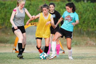 Logan Brandon/News-Register##
Yamhill-Carlton soccer players Cassidy Jackson (left) and Olivia Davison (far right) battle Nela Carolus (center) for the ball during practice. Allie Amerson looks on in the background. Logan Brandon/News-Register##
Yamhill-Carlton soccer players Cassidy Jackson (left) and Olivia Davison (far right) battle Nela Carolus (center) for the ball during practice. Allie Amerson looks on in the background.
