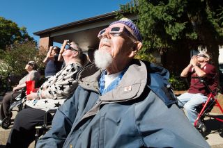 Marcus Larson/News-Register
Clifton Mesick, who was alive during the 1918 and 1979 eclipse, stares up as the moon eclipses the sun while attending the Brookdale Senior Living. Marcus Larson/News-Register
Clifton Mesick, who was alive during the 1918 and 1979 eclipse, stares up as the moon eclipses the sun while attending the Brookdale Senior Living.