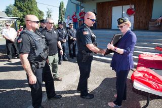 Marcus Larson / News-Register##Renee Ohler, right, commandeer of Carlton Memorial American Legion Post 173, shakes hands with Yamhill Police Officer Travis VanCleave, backed by Chief Greg Graven and Officer David Thiems, as she presents a plaque honoring their service. The Post also honored Carlton police and Yamhill and Carlton firefighters on the 9/11 anniversary. Marcus Larson / News-Register##Renee Ohler, right, commandeer of Carlton Memorial American Legion Post 173, shakes hands with Yamhill Police Officer Travis VanCleave, backed by Chief Greg Graven and Officer David Thiems, as she presents a plaque honoring their service. The Post also honored Carlton police and Yamhill and Carlton firefighters on the 9/11 anniversary.