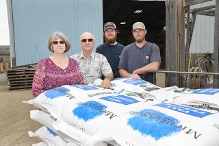 Rusty Rae/News-Register##Gretchen and Steve Jones are in the process of retiring from their Select Seed farm, which has been in the family for 100 years. To their left is grandson Nathan Jones and warehouse manager Jason Galbreath. Rusty Rae/News-Register##Gretchen and Steve Jones are in the process of retiring from their Select Seed farm, which has been in the family for 100 years. To their left is grandson Nathan Jones and warehouse manager Jason Galbreath.