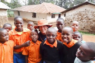 Submitted photo##Retired Linfield College professor Tara Lepp, center, with some of the children she works with in Kenya. Submitted photo##Retired Linfield College professor Tara Lepp, center, with some of the children she works with in Kenya.
