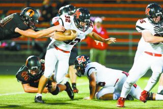 Molly Smith/Statesman Journal##
McMinnville senior running back Ray Jacob (32) is tackled by a host of Olympians in Friday night’s loss. Jacob found tough going in the contest, but managed to churn out 75 yards and the Grizzlies only score of the game, a fourth quarter three-yard romp. Molly Smith/Statesman Journal##
McMinnville senior running back Ray Jacob (32) is tackled by a host of Olympians in Friday night’s loss. Jacob found tough going in the contest, but managed to churn out 75 yards and the Grizzlies only score of the game, a fourth quarter three-yard romp.