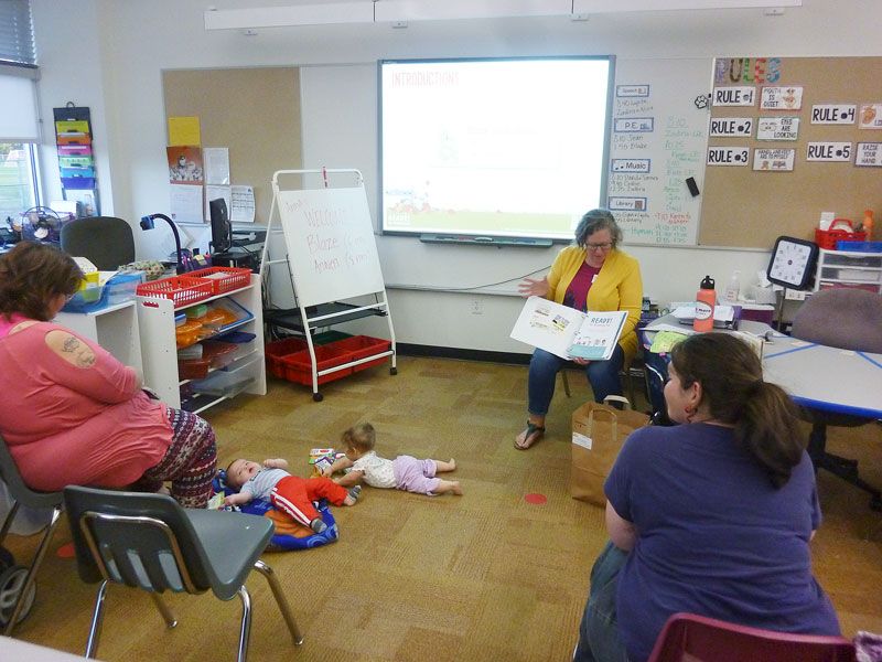 Starla Pointer / News-Register##
Teacher Anna Stahl, center, leads a Ready for Kindergarten session for babies Blaze and Anwen and their mothers, Kelly Foster, left and Melissa Jones, right. The program gives parents skills and strategies.