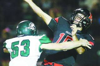 Rockne Roll/News-Register##
Grizzly QB Sam Dupuis is hit by Titan defender Alex Hurlburt as he releases the ball. Rockne Roll/News-Register##
Grizzly QB Sam Dupuis is hit by Titan defender Alex Hurlburt as he releases the ball.