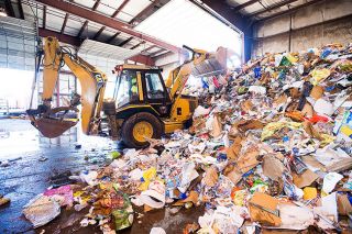 Marcus Larson/News-Register file photo##Recology worker Marcelino Ramirez uses a backhoe to sort a pile of waste, much of it contaminated recyclables, at the company’s McMinnville facility. Marcus Larson/News-Register file photo##Recology worker Marcelino Ramirez uses a backhoe to sort a pile of waste, much of it contaminated recyclables, at the company’s McMinnville facility.